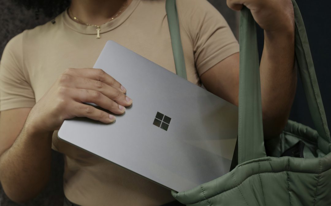 A stock image of a woman putting a computer into a shoulder bag. Stress Relief Tips for Working Moms